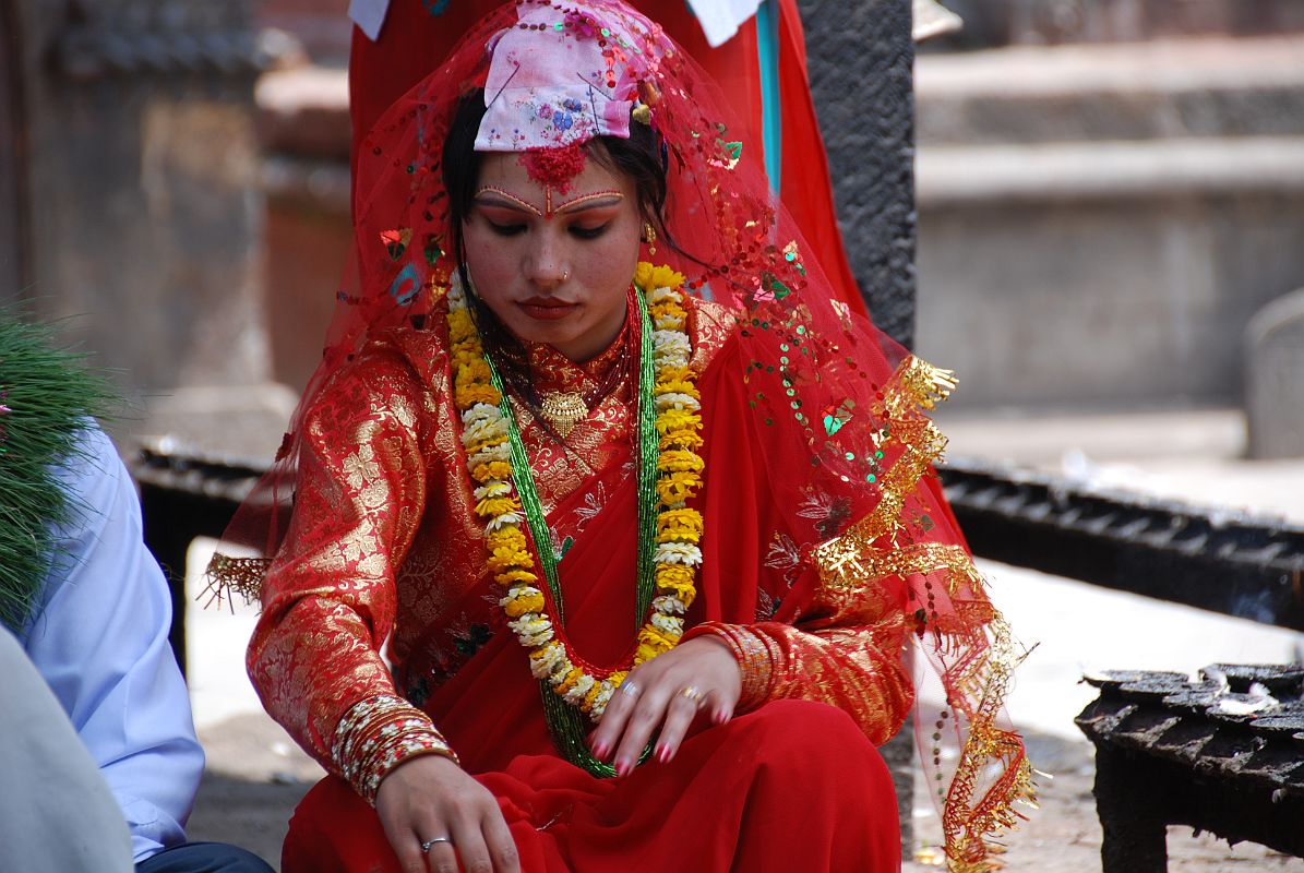 Kathmandu Patan 04 Kumbeshwar Temple 03 Hindu Wedding Ceremony Bride Close Up The Nepalese Hindu bride was dressed in a heavily embroidered red sari, beautifully made up, and wearing much jewelry at the Kumbeshwar Temple in Patan.